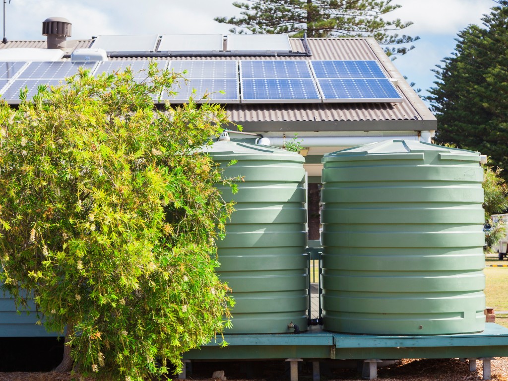 Water tanks outside a house in the bush. 